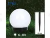 A solar garden light with a white spherical top is shown in a grassy area with rain falling. Anteprima dell’immagine prodotto