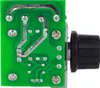 A close-up view of the back of a green circuit board with silver solder points and traces, and a black knob attached to a metal shaft on the right side. Voir les images du produit