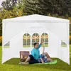 A couple relaxing inside a white gazebo in a grassy outdoor setting. Voir les images du produit