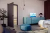 A bedroom scene with a TV on a cabinet, a plant, and a door. Produktbild-Vorschau