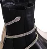 Close-up of a black boot with a snake-shaped embellishment covered in rhinestones. Produktbild-Vorschau