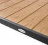A close-up view of the corner of a wooden slatted table with a black metal frame. Produktbild-Vorschau