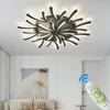 A modern living room with a ceiling light and a remote control. Produktbild-Vorschau
