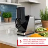 A kitchen counter with a food processor and sliced vegetables. Anteprima dell’immagine prodotto