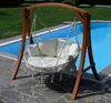 A hanging chair with cushions is placed next to a swimming pool. Produktbild-Vorschau