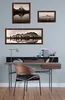 A desk with a chair and framed pictures on the wall. Produktbild-Vorschau