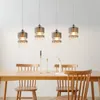A dining table with chairs and a chandelier hanging above. Podgląd zdjęcia produktu
