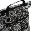A close-up view of a black and white floral patterned bag with zippers and handles. Podgląd zdjęcia produktu