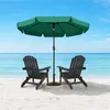 Two dark Adirondack chairs and a green umbrella on a sandy beach with the ocean and sky in the background. Produktbild-Vorschau