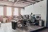 An office environment with people working at desks, and a trash can in the foreground. Produktbild-Vorschau