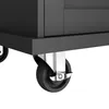 A close-up view of the bottom part of a black kitchen cart, showing one of its wheels and part of the frame. Produktbild-Vorschau