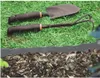 Gardening tools and edging are placed on grass and mulch. Náhled obrázku produktu