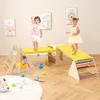 Children playing on a wooden climbing structure indoors. Produktbild-Vorschau