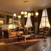 A luxurious living room with a leather sofa, coffee table, and a large window with sunset views. Náhľad obrázku produktu