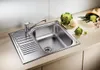 A stainless steel kitchen sink with a faucet and a draining board, placed on a countertop. Vegetables like cauliflower and romanesco broccoli are arranged on the countertop next to the sink. Náhľad obrázku produktu