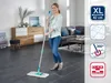 A woman is cleaning a floor with a mop in a living room. Anteprima dell’immagine prodotto