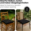 Two chairs with black seat cushions are shown outdoors on a balcony or patio. Produktbild-Vorschau