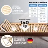 A close-up view of a wooden bed frame with adjustable slats, showing its construction and features. Produktbild-Vorschau
