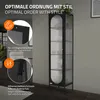 A tall, narrow black display cabinet with glass doors and shelves, placed in a room setting. Podgląd zdjęcia produktu
