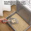 A hand is scooping waste from a cat litter box filled with pellets. Produktbild-Vorschau