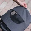 A hand is adjusting the canopy of a stroller. Náhľad obrázku produktu