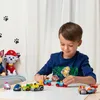 A young boy is playing with Paw Patrol toy cars on a table. Anteprima dell’immagine prodotto