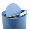 A close-up view of the top of a pastel blue trash can with a silver trim and a partially open lid. Voir les images du produit