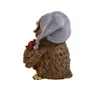 A side view of a decorative owl figurine wearing a nightcap and holding a small teddy bear. Produktbild-Vorschau
