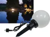 A garden light with a stake and cord is shown next to a nighttime scene of a pond illuminated by garden lights. Produktbild-Vorschau