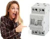 A woman is pointing at an electrical switch. Produktbild-Vorschau