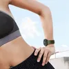 A person wearing a sports bra and workout pants, with a smartwatch on their wrist, against a bright sky background. Náhled obrázku produktu
