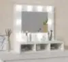 A makeup vanity with a lighted mirror and shelves. Anteprima dell’immagine prodotto