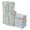 A stack of folded blankets and one unfolded blanket with a dinosaur pattern. Náhled obrázku produktu