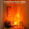 A room corner with a lamp projecting light onto the walls, a framed picture, and a laptop. Anteprima dell’immagine prodotto