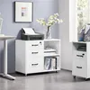 A white filing cabinet with drawers and an open shelf, a printer on top, and a vase of flowers on a desk next to it. The cabinet is in an office setting. Produktbild-Vorschau