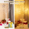 A split image showing a decorative LED birch tree in two different lighting conditions, with Christmas decorations and gifts. Anteprima dell’immagine prodotto