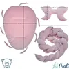A product image displaying a pink baby nest, a pink bow-shaped pillow, and a pink braided bumper with dimensions indicated by measurement lines and text. Náhled obrázku produktu