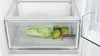 A close-up view of a refrigerator's crisper drawer filled with fresh produce. Produktbild-Vorschau