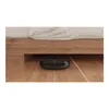 A black robot vacuum cleaner is cleaning under a wooden bed frame. Podgląd zdjęcia produktu