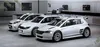 Three white rally cars are lined up in a garage or workshop setting. Podgląd zdjęcia produktu
