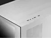 A close-up view of the top panel of a white computer case, showing various ports and a textured surface. Náhled obrázku produktu