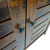 A close-up view of two dark brown wooden cabinet doors with black knobs. Produktbild-Vorschau