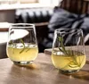 Two glasses of yellow liquid with rosemary sprigs on a wooden table. Náhľad obrázku produktu