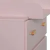 A close-up view of a pink dresser with wooden knobs. Podgląd zdjęcia produktu