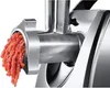 A close-up shot of a meat grinder with ground meat coming out of the grinder. Voir les images du produit