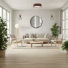 A modern living room with a sofa, chairs, coffee table, and plants, illuminated by natural light from large windows. Produktbild-Vorschau