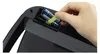 A hand is inserting batteries into a black electronic device. Podgląd zdjęcia produktu