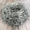 A tangled mass of LED string lights on a wooden floor. Produktbild-Vorschau
