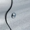 A close-up of a metal screw fastening two pieces of corrugated metal together. Produktbild-Vorschau