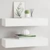 Two white floating shelves mounted on a white wall, each displaying decorative items. Produktbild-Vorschau